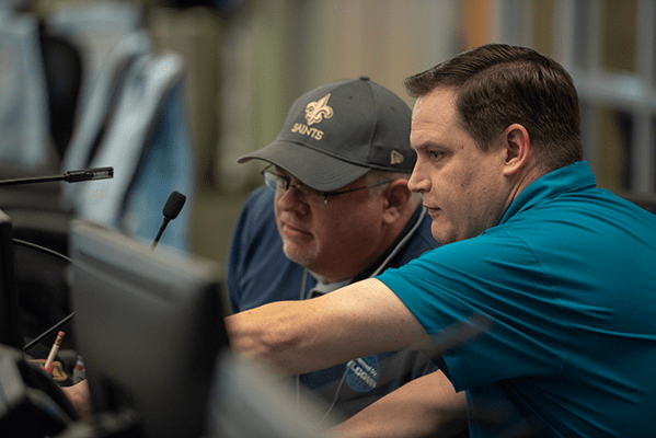 Ned Cake and Patrick Pence working during a hurricane